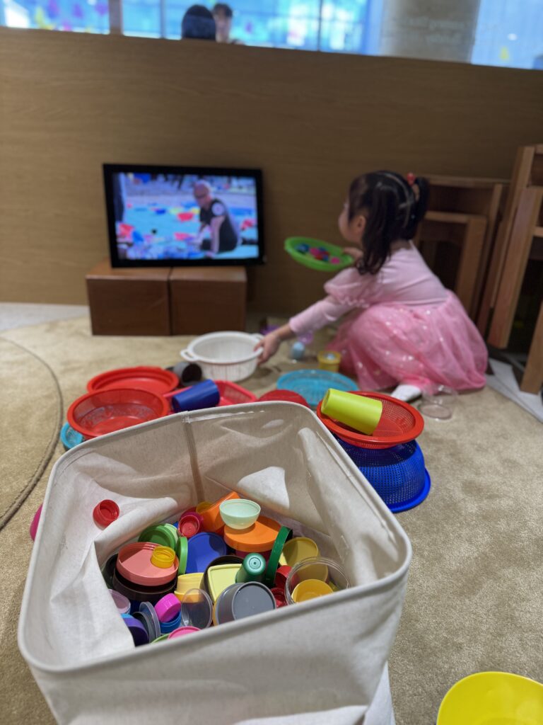 A child playing with colorful objects in a hands-on workshop at MMCA SPACE KIDS, MMCA Seoul
