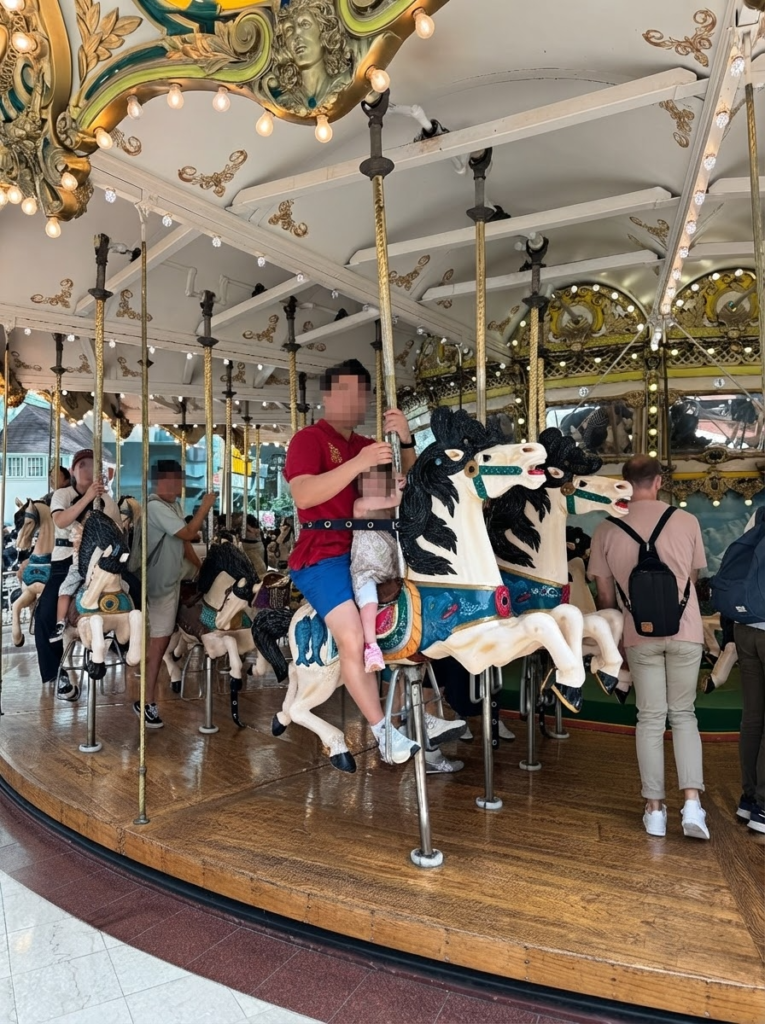 Parent and toddler riding the classic carousel at Lotte World Adventure in Seoul