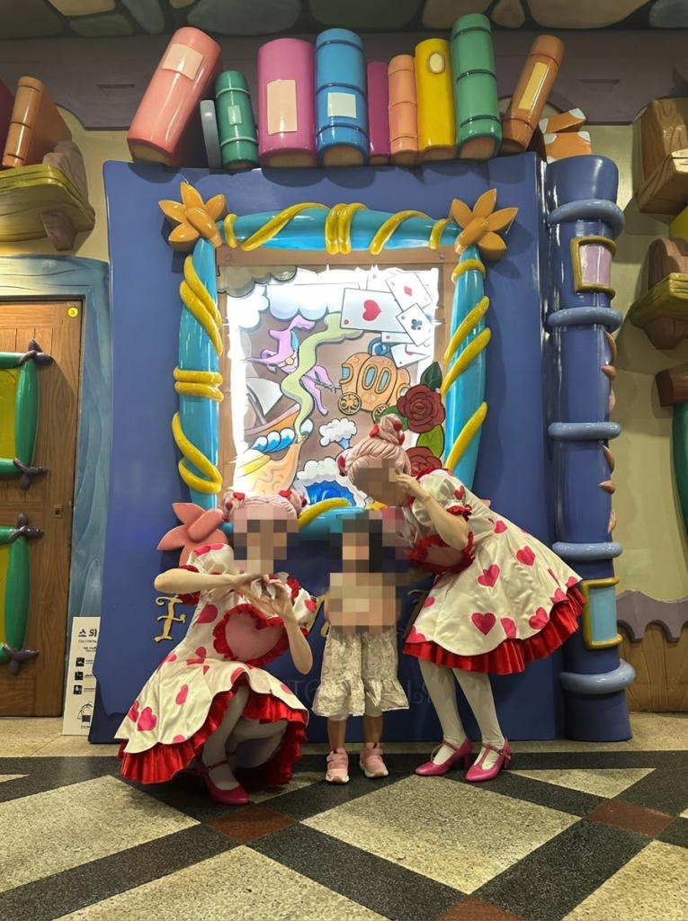  Child posing with two costumed fairy-tale characters at Lotty's Kidstoria in Lotte World Seoul