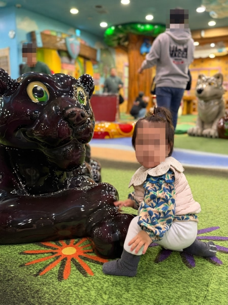 Child playing next to a large black jaguar statue at Lotty's Kidstoria indoor play zone in Lotte World