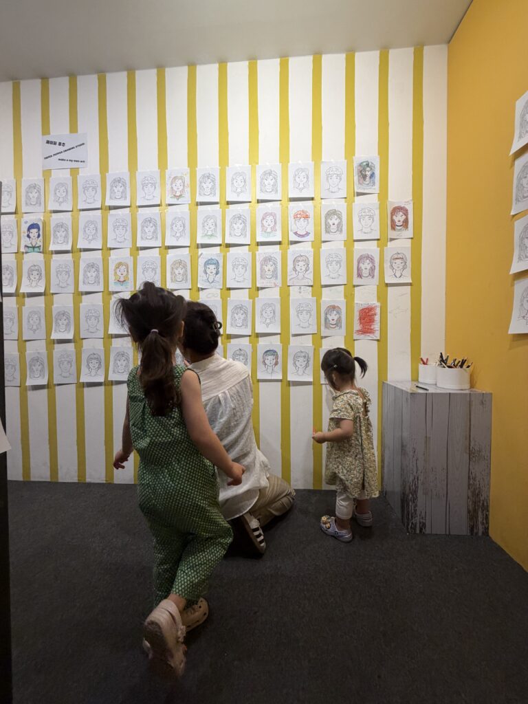 Kids coloring in artwork at an interactive wall in the Paper Pepper exhibition, Blue Square Seoul