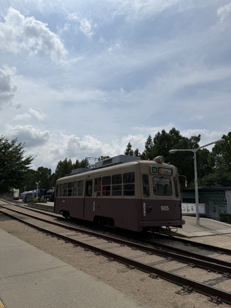 Vintage tram number 906 displayed on tracks at Hwarangdae Railroad Park