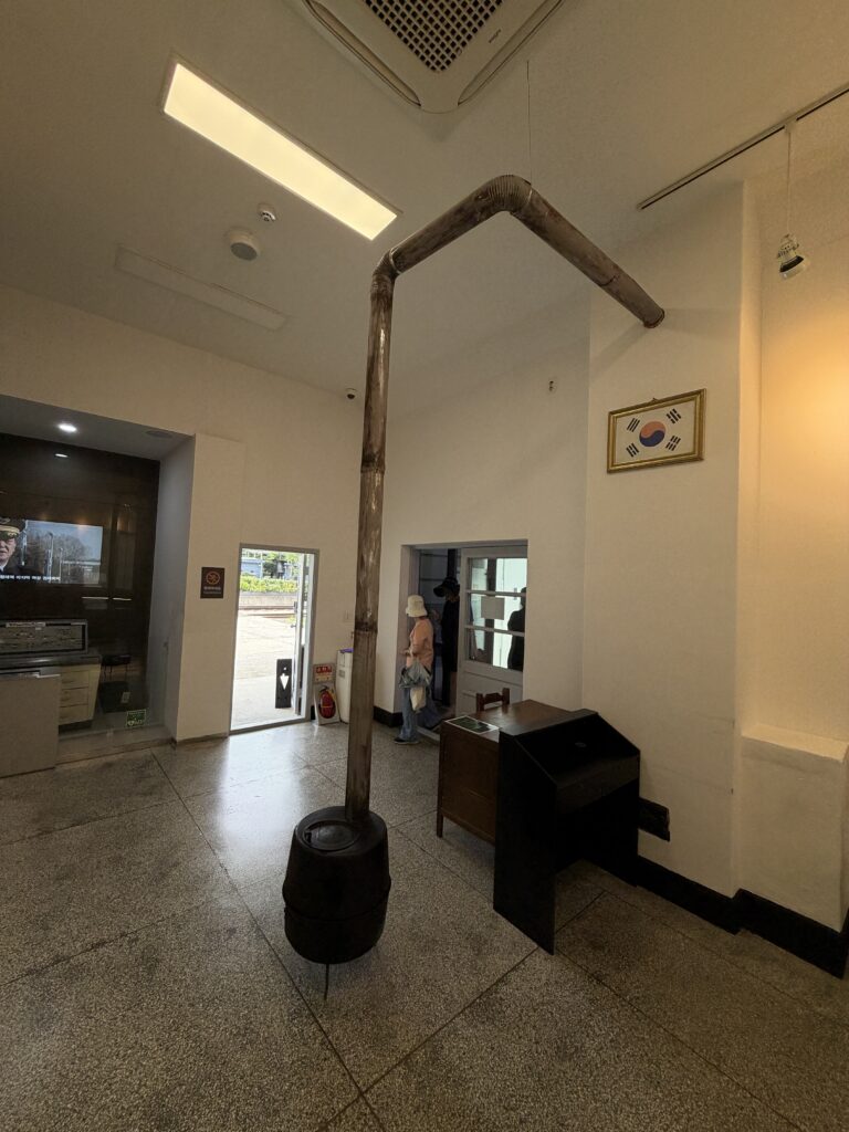Interior of Hwarangdae Station history hall with an old coal stove and chimney