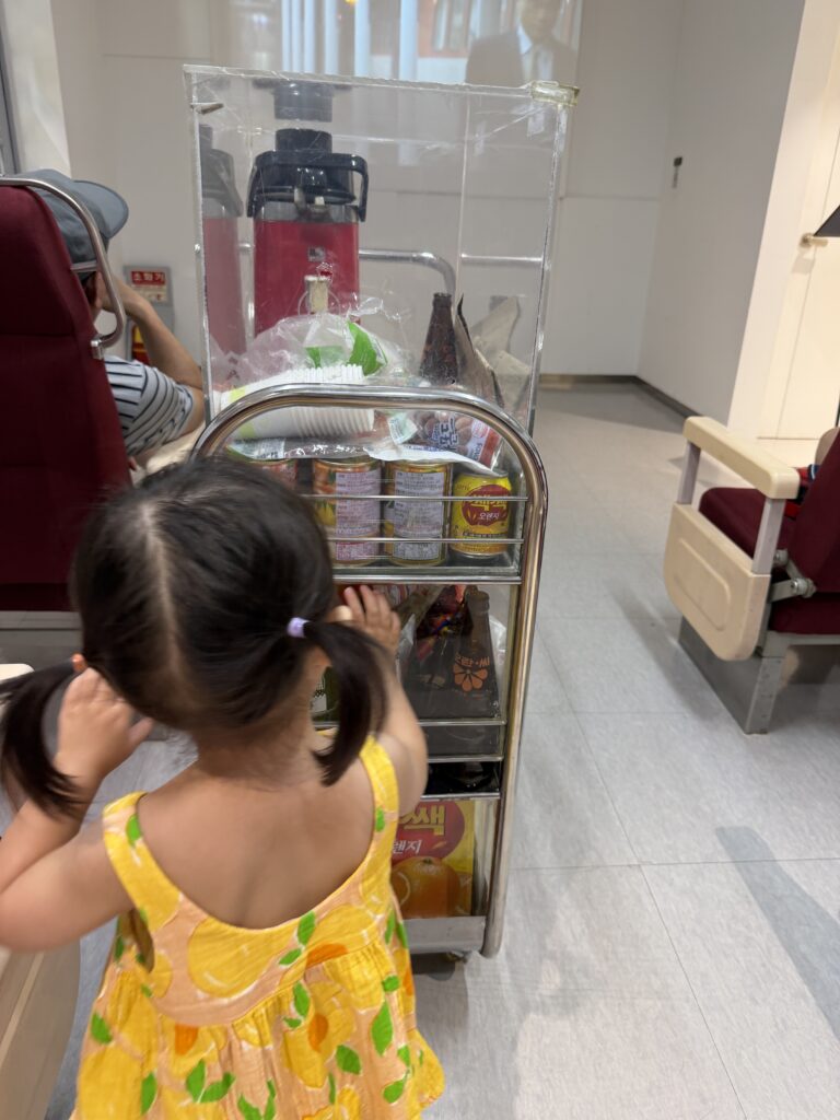 Young child looking at a recreated train snack cart inside an old carriage