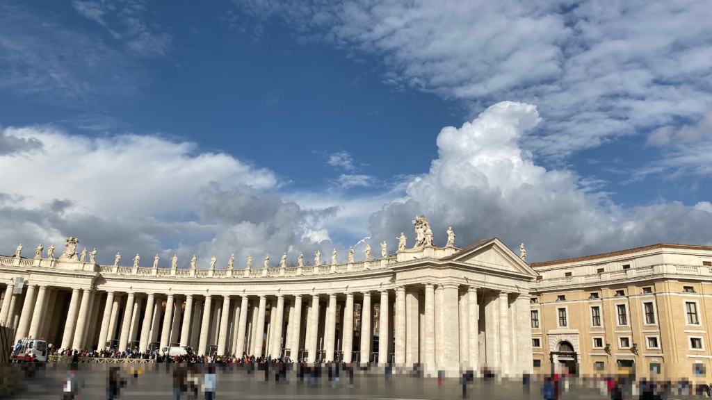 St. Peter's Square colonnade in Vatican City under a bright blue sky