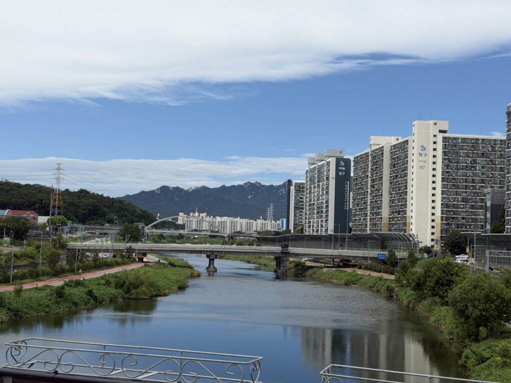 View of Jungnang Stream and the northern Seoul mountain ridges from the Gyeongchun railway bridge, Nowon, Seou