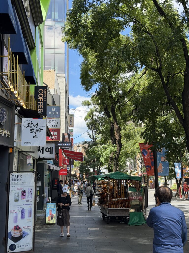 Insadong Street in Seoul on a sunny afternoon, with willow trees, galleries and pedestrians