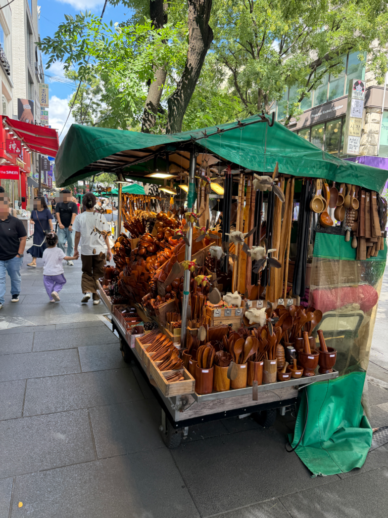  wooden craft cart on Insadong Street in Seoul loaded with carved spoons, chopsticks, bowls and mortars