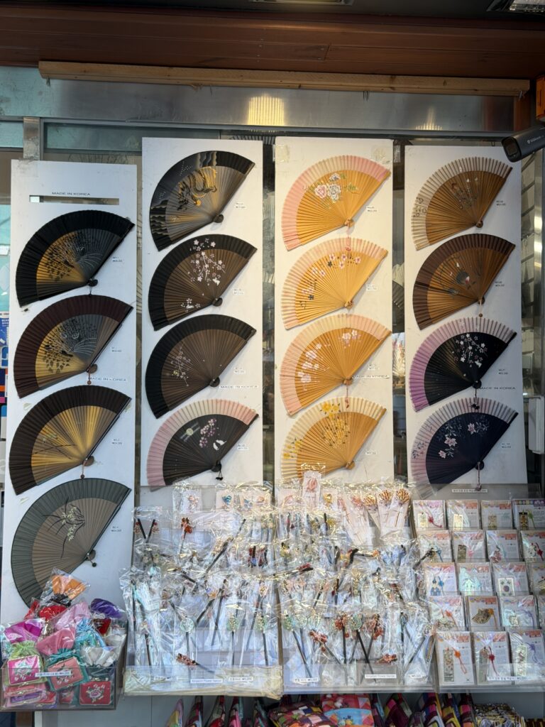 Display of Korean folding fans and decorative hairpins labelled Made in Korea at a shop in Insadong