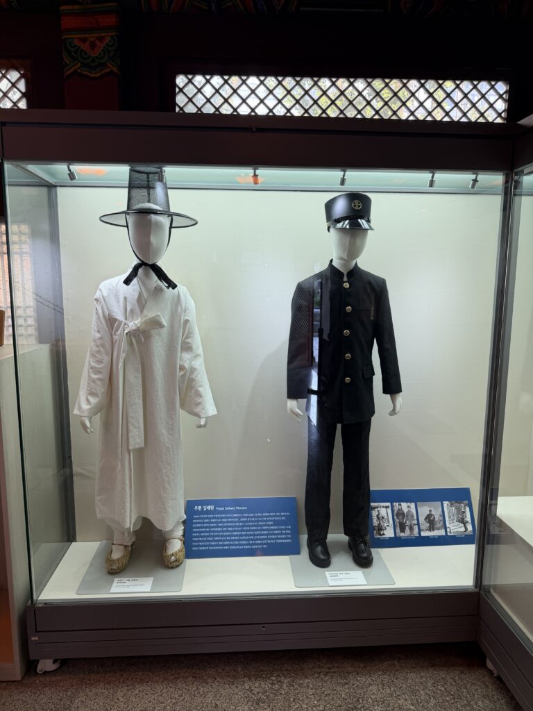 Two historic Korean postal uniforms displayed at the Korea Postal Museum in Seoul