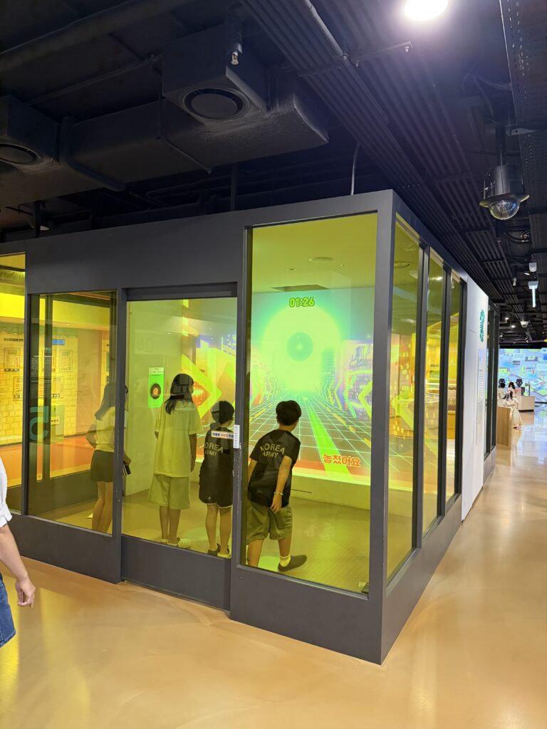 Glass-walled activity room at the children's museum with a countdown timer projected on the back wall