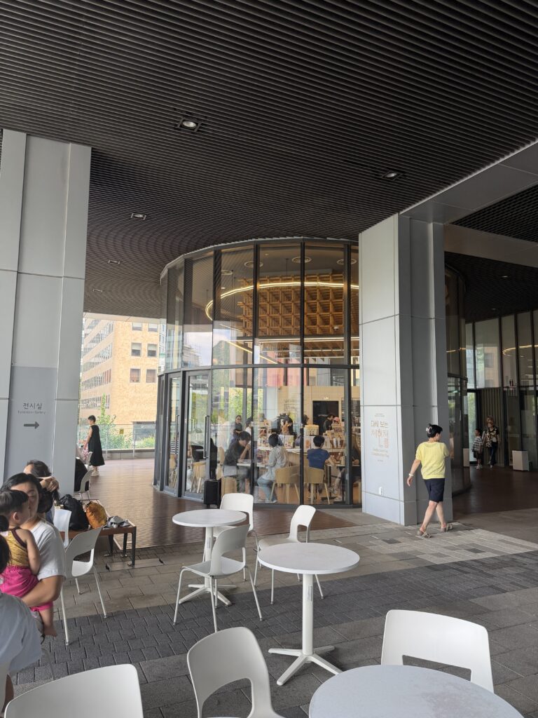Café with outdoor tables under a deep overhang at the National Museum of Korean Contemporary History